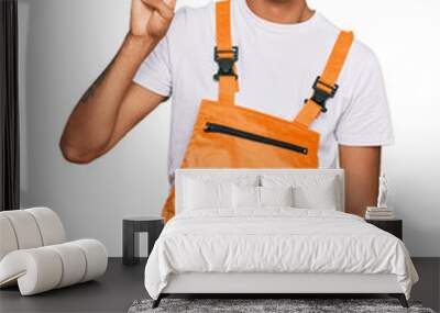 Young handsome african american man wearing handyman uniform showing and pointing up with fingers number four while smiling confident and happy. Wall mural