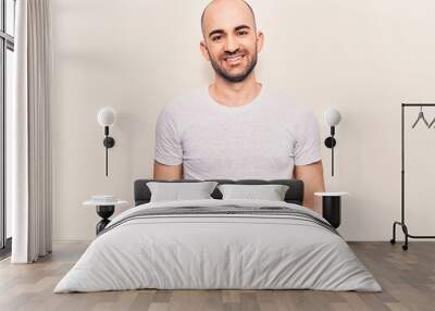 Young handsome bald man wearing casual t shirt with a happy and cool smile on face. lucky person. Wall mural