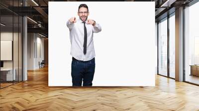 Young handsome business man wearing glasses over isolated background Pointing to you and the camera with fingers, smiling positive and cheerful Wall mural