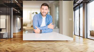 Young handsome man at home happy face smiling with crossed arms looking at the camera. Positive person. Wall mural