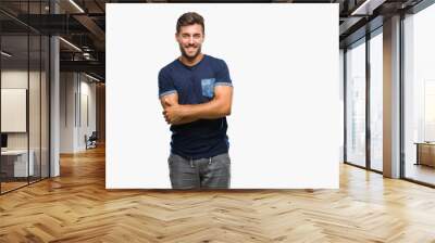 Young handsome man over isolated background happy face smiling with crossed arms looking at the camera. Positive person. Wall mural