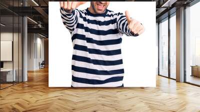 Young handsome man wearing burglar mask approving doing positive gesture with hand, thumbs up smiling and happy for success. winner gesture. Wall mural