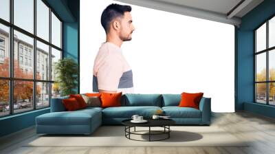 Young handsome man wearing casual clothes looking to side, relax profile pose with natural face with confident smile. Wall mural