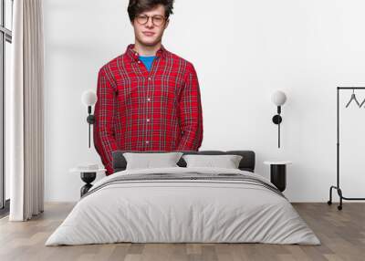 Young handsome man wearing glasses over isolated background Relaxed with serious expression on face. Simple and natural looking at the camera. Wall mural