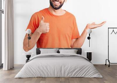 Young handsome man with beard wearing casual t-shirt showing palm hand and doing ok gesture with thumbs up, smiling happy and cheerful Wall mural