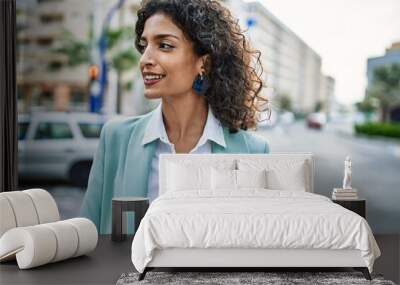 Young hispanic business woman wearing professional look smiling confident at the city Wall mural