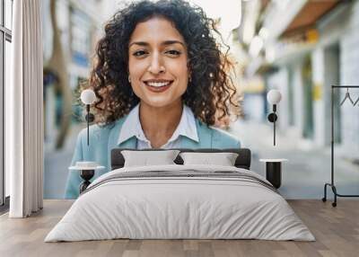 Young hispanic business woman wearing professional look smiling confident at the city Wall mural