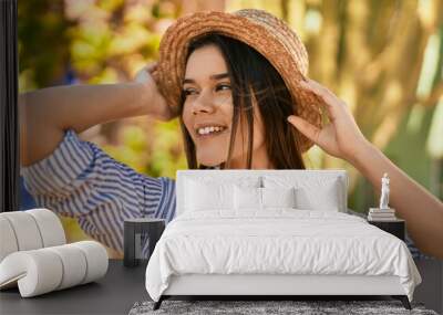 Young hispanic girl smiling happy standing at the park. Wall mural