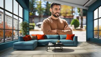 Young hispanic man smiling confident standing with arms crossed gesture at park Wall mural