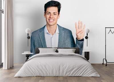 Young hispanic man wearing business clothes showing and pointing up with fingers number four while smiling confident and happy. Wall mural