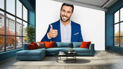 Young hispanic man wearing business jacket doing happy thumbs up gesture with hand. approving expression looking at the camera showing success. Wall mural