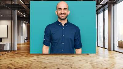 Young hispanic man wearing casual clothes with a happy and cool smile on face. lucky person. Wall mural