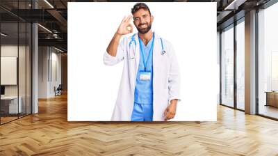 Young hispanic man wearing doctor uniform and stethoscope smiling positive doing ok sign with hand and fingers. successful expression. Wall mural