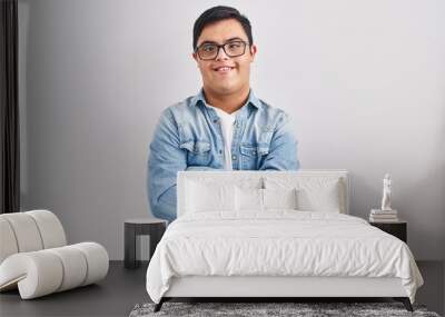 Young hispanic man with down syndrome wearing casual denim jacket over white background happy face smiling with crossed arms looking at the camera. positive person. Wall mural