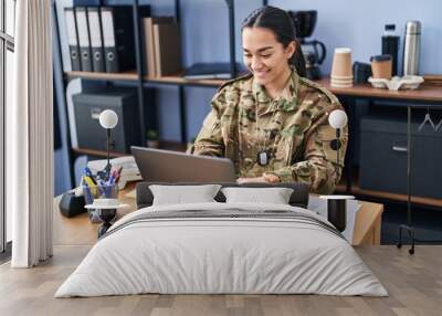 Young hispanic woman army soldier using laptop at office Wall mural