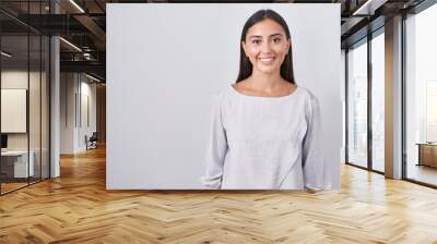 Young hispanic woman standing over white background with a happy and cool smile on face. lucky person. Wall mural