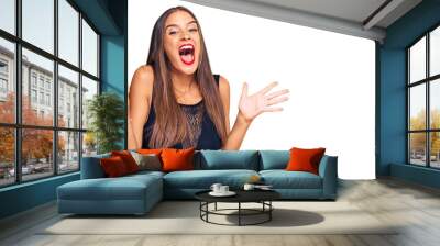 Young hispanic woman wearing casual clothes celebrating crazy and amazed for success with arms raised and open eyes screaming excited. winner concept Wall mural