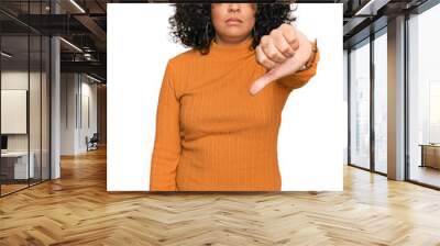 Young hispanic woman wearing casual clothes looking unhappy and angry showing rejection and negative with thumbs down gesture. bad expression. Wall mural