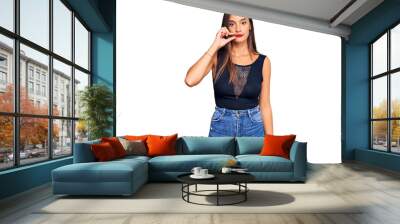 Young hispanic woman wearing casual clothes mouth and lips shut as zip with fingers. secret and silent, taboo talking Wall mural