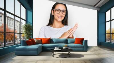 Young hispanic woman wearing casual white t shirt clapping and applauding happy and joyful, smiling proud hands together Wall mural