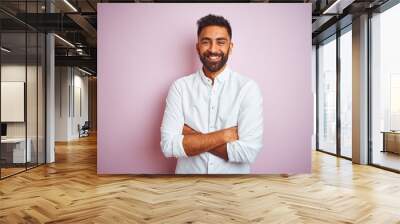 Young indian businessman wearing elegant shirt standing over isolated pink background happy face smiling with crossed arms looking at the camera. Positive person. Wall mural