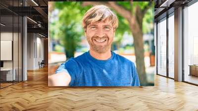 Young irish man smiling happy making selfie by the camera at the park. Wall mural