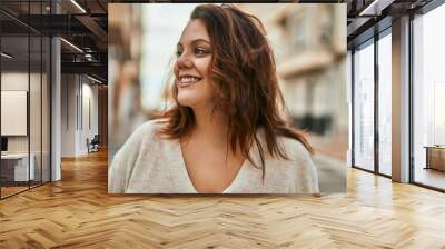 Young irish plus size girl smiling happy standing at the city. Wall mural