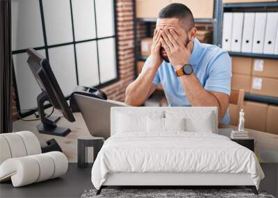 Young latin man ecommerce business worker stressed using laptop at office Wall mural