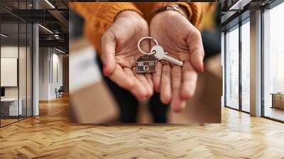 Young latin woman holding key of new house at new home Wall mural