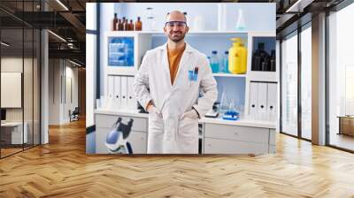 Young man scientist standing at laboratory Wall mural