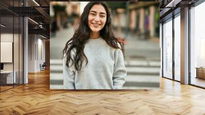 Young middle east girl smiling happy standing at the city. Wall mural