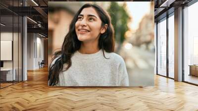 Young middle east girl smiling happy standing at the city. Wall mural