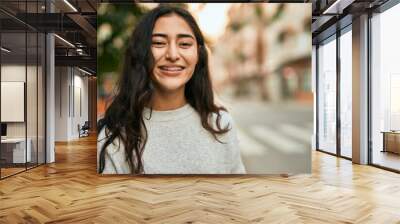 Young middle east girl smiling happy standing at the city. Wall mural