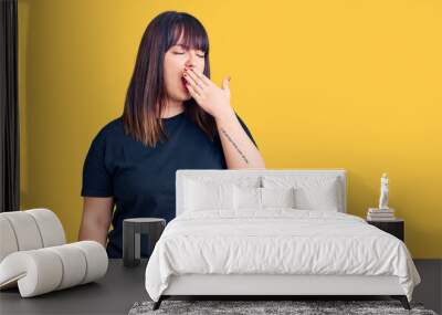 Young plus size woman wearing casual clothes bored yawning tired covering mouth with hand. restless and sleepiness. Wall mural