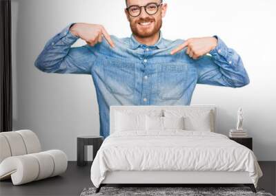 Young redhead man wearing casual denim shirt looking confident with smile on face, pointing oneself with fingers proud and happy. Wall mural