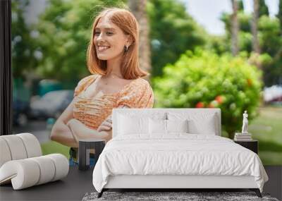 Young redhead woman smiling confident standing with arms crossed gesture at park Wall mural