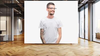 Young tattooed adult man looking away to side with smile on face, natural expression. Laughing confident. Wall mural