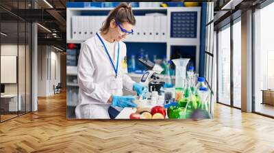 Young woman scientist smiling confident working at laboratory Wall mural