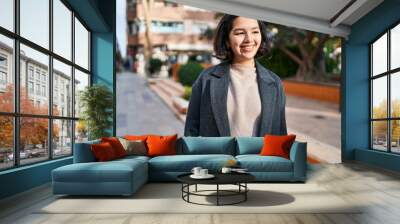 Young woman smiling confident looking to the side at park Wall mural