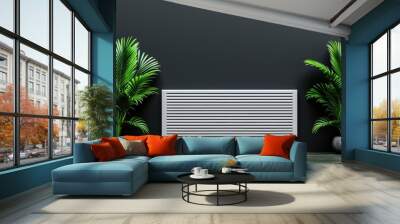 Modern interior design with a sleek radiator between two lush green plants against a dark wall backdrop. Wall mural