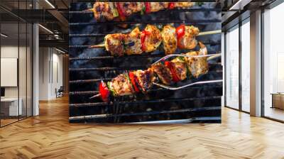 Close up pf delicious chicken breast on wooden skew with fresh vegetables, garlic, paprika fried on mangal barbeque grill Wall mural