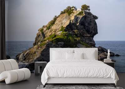 Featured in the hit film musical 'Mama Mia', the chapel of St John the Baptist sits dramatically on the top of a finger of rock off the island of Skopelos in the Aegean sea in Greece. Wall mural