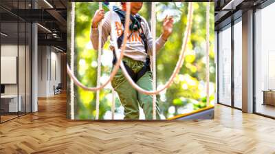 brave little boy in helmet climbing at adventure park in autumn season. Work out concept Wall mural