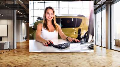 Young woman working at the modern office desk with a laptop, busy with distance learning, tutoring, making online surveys. Lady boss at her workplace. Business success concept. People at work concept Wall mural