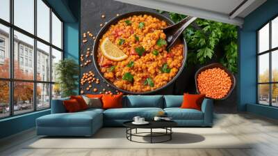 Red lentils dal in black bowl on dark slate table top. Lentils tomato dhal is indian cuisine dish with lemon and ciliantro. Indian food. Asian vegetarian meal Wall mural