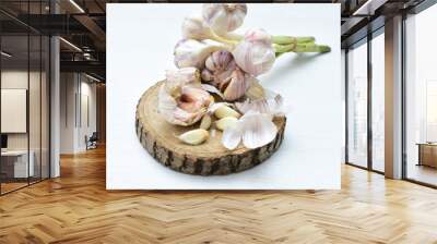 Heads of garlic, ripe white corsage on white wooden background Wall mural