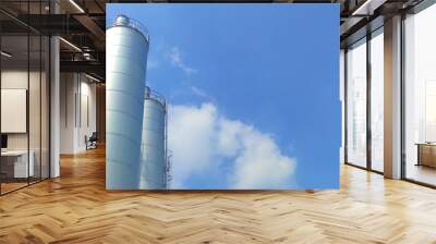 flour storage silo machine before production use, bright blue sky background Wall mural