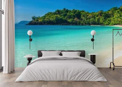 Scenic tropical beach with crystal clear blue waters and white sandy shores. Wall mural