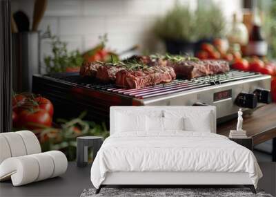 electric grill with tasty steaks and tomatoes on table Wall mural