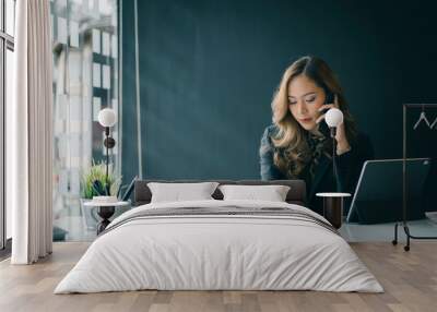 Portrait of beautiful smiling young  entrepreneur businesswoman working in modern work station. Wall mural